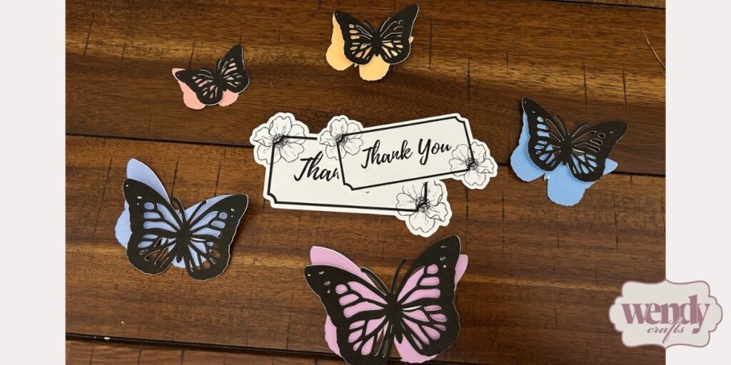 Finished Cricut butterfly designs and Thank You inscription designs.