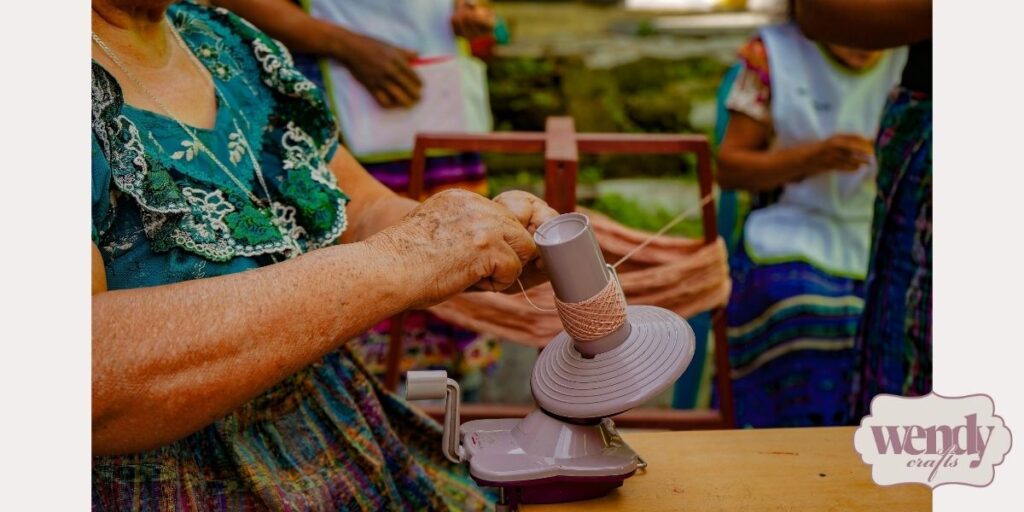 A group of women working with handmade thread.